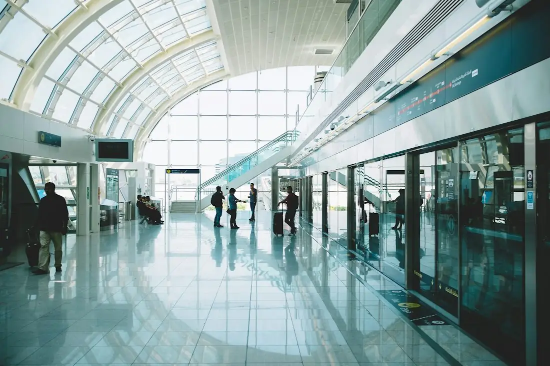 Travellers in a bright UAE airport terminal